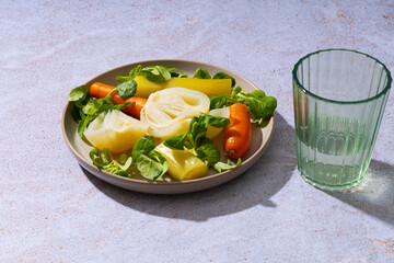 Plate of steamed vegetables on a stone table