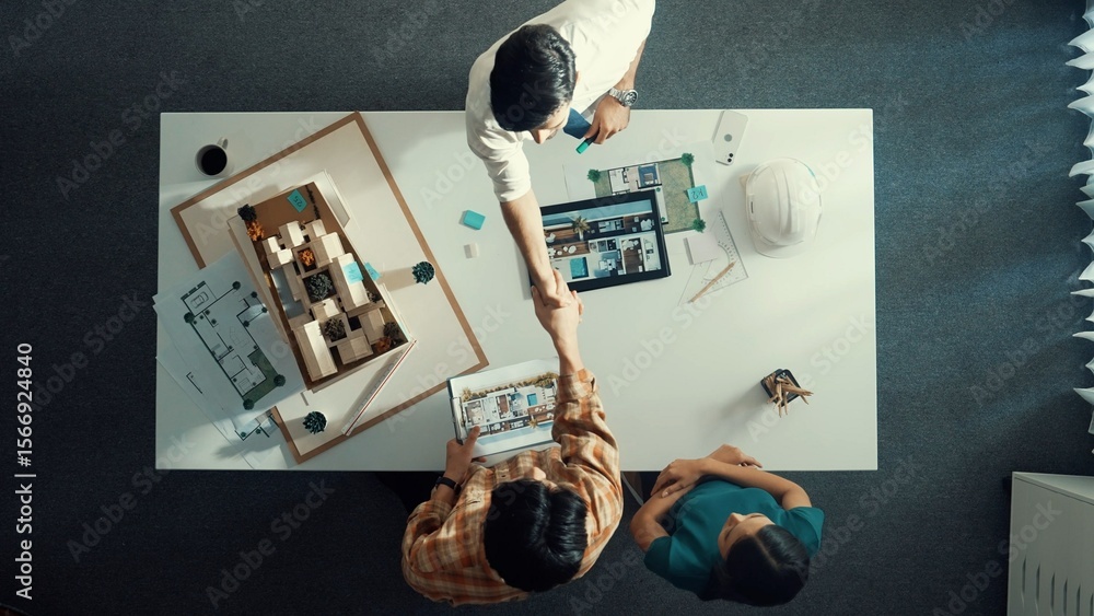 Poster top view of architect engineer working together and shaking hand cooperative team while making contr