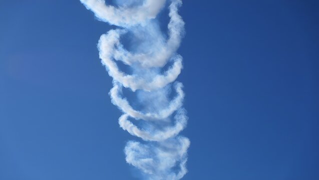 White Spiral Smoke Rings in Clear Blue Sky