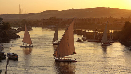 felucca boats on Nile river in Aswan at sunset