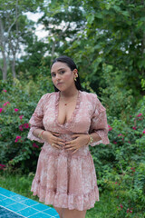 Fashion model posing in a garden setting, embracing natural beauty