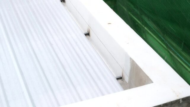 Detailed view of corrugated metal roof sheet and PU foam insulation sandwich panel, precise form for modern building construction and insulated roof applications