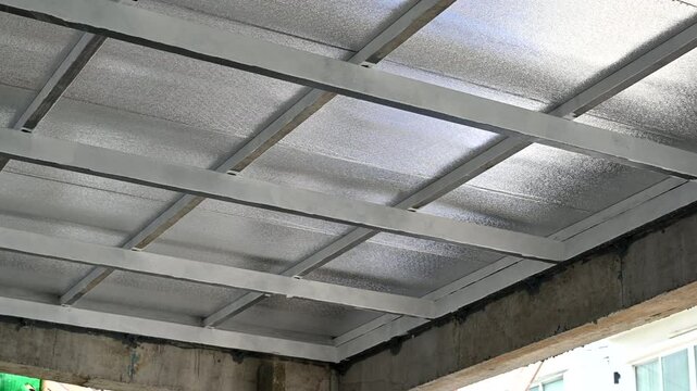 Industrial ceiling construction using metal sheet panels. Polyurethane pu form insulation creating functional and strong thermal barrier for modern building design