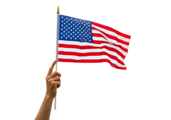A hand holds a waving US flag against a black background