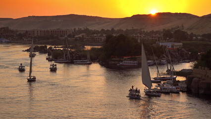 felucca boats on Nile river in Aswan at sunset