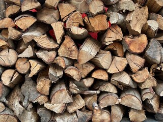 chopped firewood stacked in a cord ready for a fire