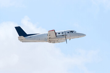 Propeller Plane in Flight Over Clear Tropical Skies