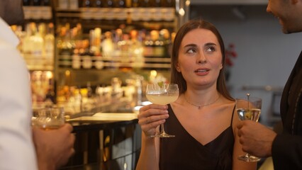 Focusing beautiful woman lively talking with friends while enjoy drinking Margarita cocktail at luxurious counter bar nightclub creating vibrant engaging atmosphere on Friday night meeting. Vinosity.