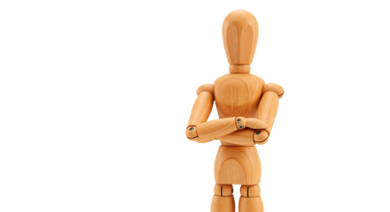 A wooden artist's mannequin stands with arms crossed against a black backdrop.