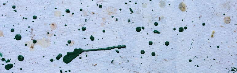 A light canvas with dynamic splashes of green paint and organic stains creates a visually...