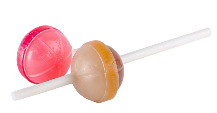 Two colorful lollipops with pink and caramel colors on white background with reflection visible