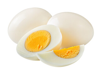 Whole and sliced hard boiled eggs with yellow yolk on a plain white background in bright light