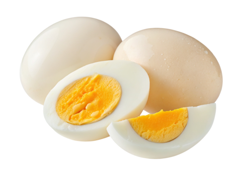 Whole eggs and sliced hard-boiled eggs on a plain white background in a close-up arrangement