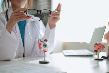 The ophthalmologist lets the patient choose the eyeglass frames that fit their face and sends them...