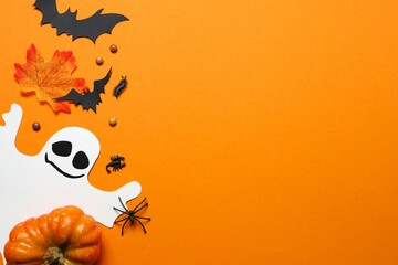 Halloween holiday decorations including ghost, pumpkin, spiders, bats on orange background