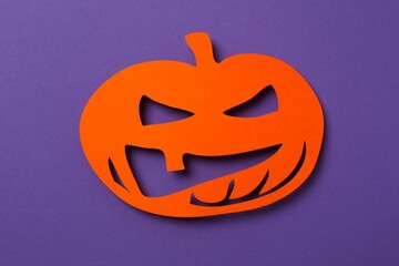 Happy Halloween holiday concept. Orange pumpkin on color background. Top view