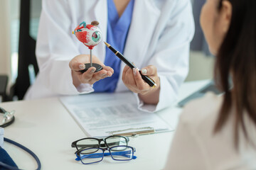 The ophthalmologist lets the patient choose the eyeglass frames that fit their face and sends them...