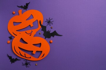 Halloween festive background design featuring decorative orange pumpkins, black bats, spiders and...