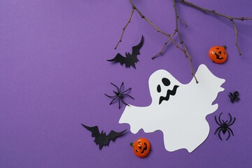 Halloween festive background design featuring bats, ghost, spiders and decorative branches