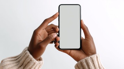 Close up hands of woman showing smartphone against white background. African woman hands touching blank screen of cellphone over white wall. Close up hands using app on mobile phone., no logos, no br