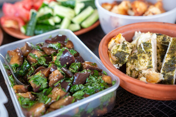 Eggplant Salad Chicken Tomatoes Appetizers arranged indoors for lunch or dinner on table for meal.