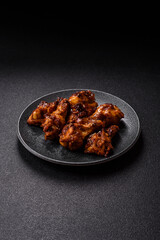 Grilled or barbecued chicken wings with teriyaki sauce, spices and sesame seeds. Teriyaki chicken