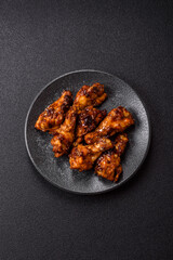 Grilled or barbecued chicken wings with teriyaki sauce, spices and sesame seeds. Teriyaki chicken