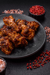 Grilled or barbecued chicken wings with teriyaki sauce, spices and sesame seeds. Teriyaki chicken