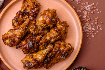 Grilled or barbecued chicken wings with teriyaki sauce, spices and sesame seeds. Teriyaki chicken