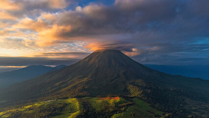 Wiew of Arenal Volcano with Golden Clouds at Sunrise