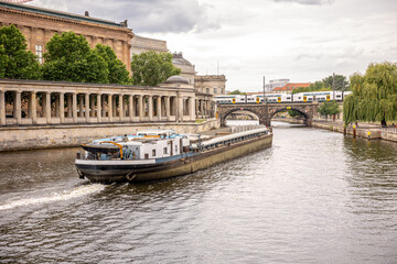 River vessel. Stone bridge with train. Classical architecture and transport
