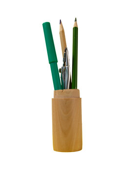 Pencils, a marker, and a compass in a standing wooden holder on a clean white background.