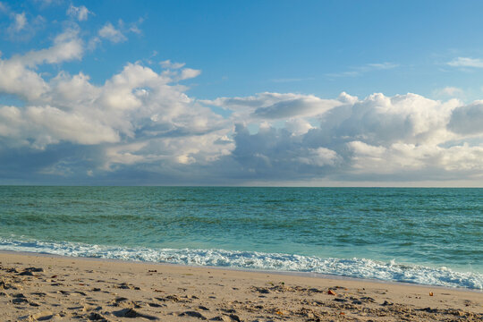 Sandy beach in Nokomis Florida with turquoise Gulf of Mexico under bright cloud sky. High quality photo