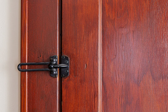 Vintage Wooden Door Lock and Latch on Aged Red Brown Timber Surface. High quality photo