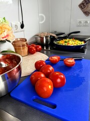 Sliced Roma Tomatoes on a Wooden Cutting Boar Slices of fresh plum tomatoes with eggs, basil, and a...