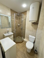 Compact Modern Bathroom with Shower Cabin and Water Heater