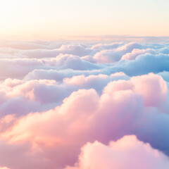 A dreamy, ethereal photograph of pastel-colored clouds in a soft, gradient sky. The clouds are layered, with a bottom layer of pure white clouds and an upper layer of pink and peach-colored clouds.