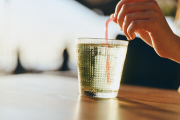 lifestyle woman enjoying refreshing drink in modern boho-western denim style with film color...