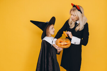 Mother and Daughter Carving a Jack o' lantern for Halloween Celebration