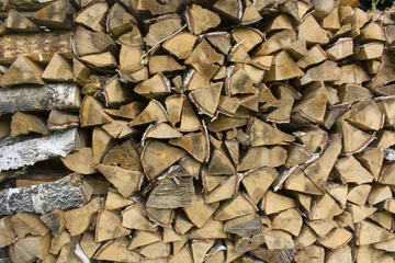 Fototapete Rund A woodpile with stacked firewood. Textured background of chopped firewood for kindling and heating the house. Birch logs. © LUBO