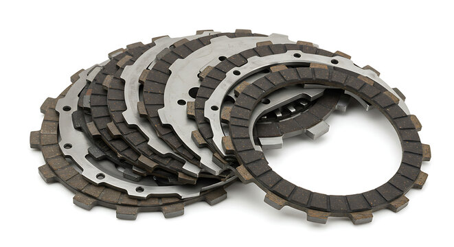 A complete motorcycle clutch kit, featuring a new set of friction and steel plates, neatly fanned out and isolated on a clean white background. - Powered by Adobe