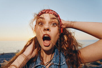 surprised woman in modern boho-western denim street style with expressive face and film color...