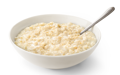 Oatmeal porridge in white bowl isolated on white
