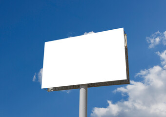 A big blank white billboard stands prominently against a clear blue sky with scattered clouds, ready for advertising content. This clean, empty sign serves as an ideal mock-up for various campaigns.
