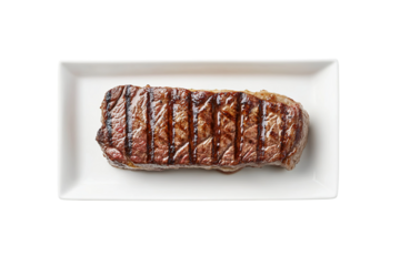 Photo of a perfectly grilled steak on a white rectangular plate, centered and isolated against a clean, solid isolated on a transparent background in PNG format.