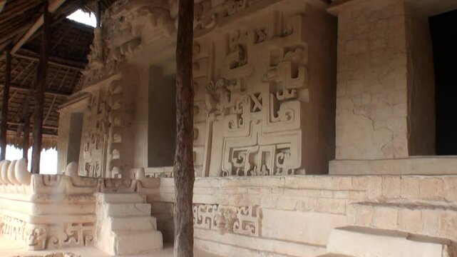 Explore the mesmerizing Acropolis at the Ek Balam archaeological site in Yucatan, Mexico. Stone steps lead to the entrance of the ancient Mayan structure, adorned with intricate carvings.