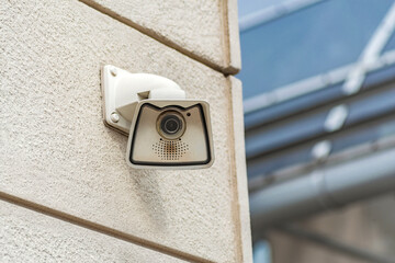 Modern Outdoor Security Camera Mounted on Building Wall for Surveillance