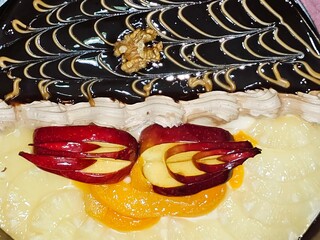 Round birthday cake of two halves different pieces sponge creamy cake for celebrations, dark...