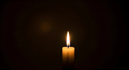 burning candle on a dark background