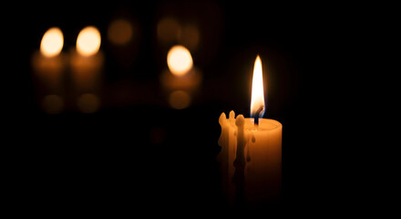 burning candle on a dark background